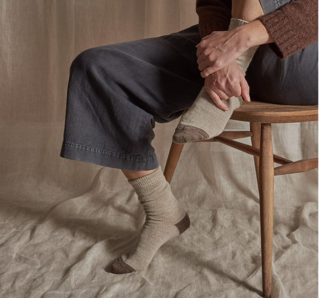 http://wanderstatemercantile.com/cdn/shop/files/rove-made-in-the-uk-merino-wool-socks-in-natural-color-on-woman.png?v=1698169261